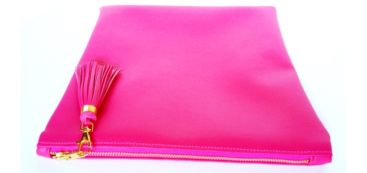Win this hot pink fold-over clutch bag from Qmuro
